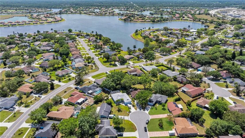 Birds eye view of property with a residential view and a water view