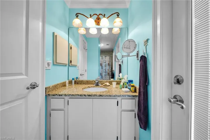 Full bathroom with a shower with curtain, vanity, and crown molding