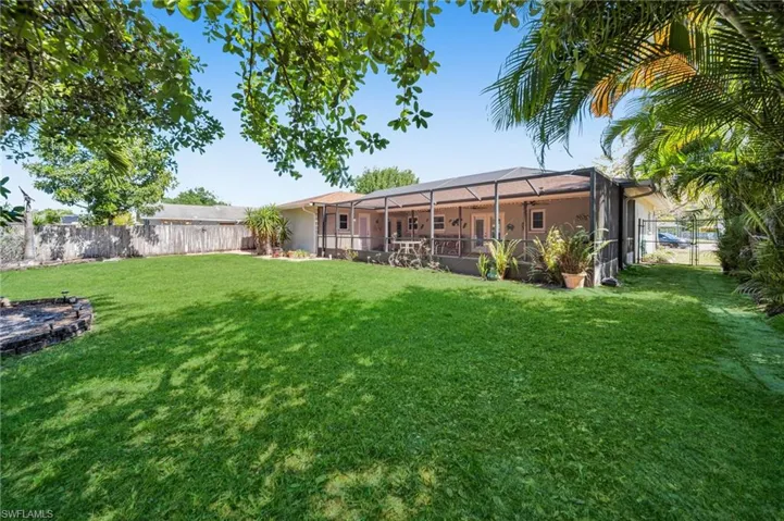 View of yard with a lanai and a fenced backyard