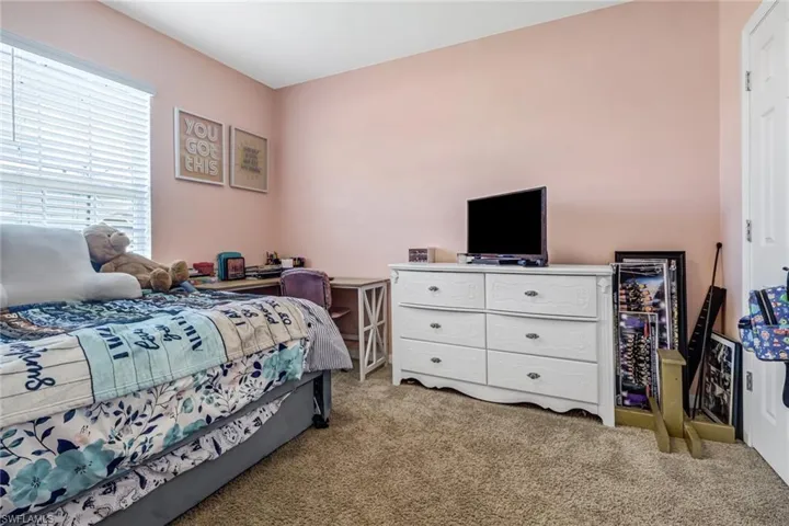 Bedroom with light carpet