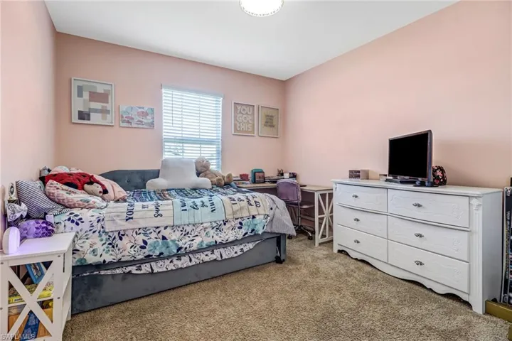 Bedroom featuring light colored carpet