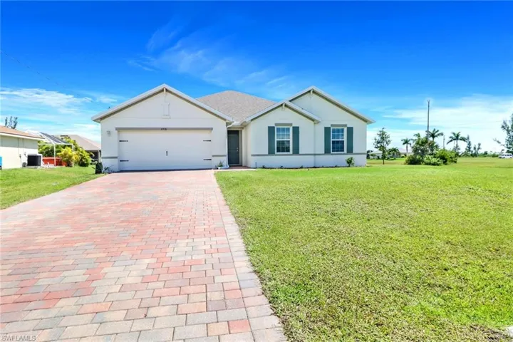 Single story home with a front lawn and a garage