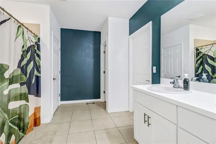 Bathroom featuring tile patterned floors and vanity