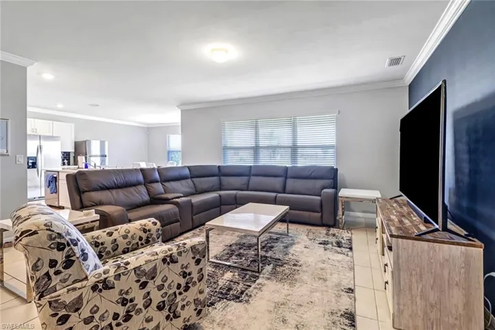 Tiled living room featuring ornamental molding