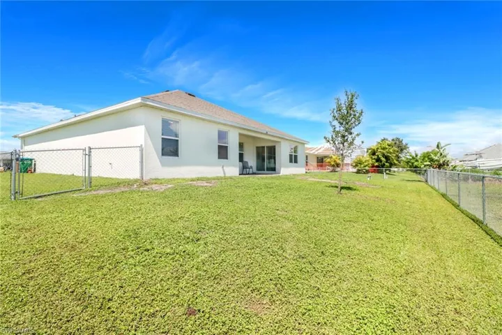 Back of house with a lawn