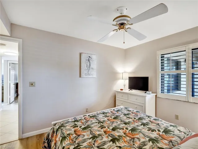 Bedroom with a ceiling fan and light wood finished floors