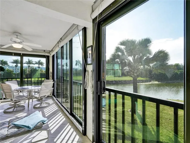 Sunroom featuring a water view and tile patterned floors