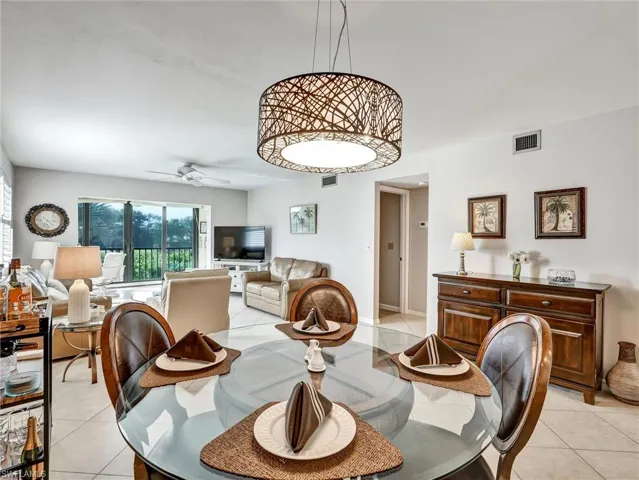 Dining space with ceiling fan and light tile patterned floors