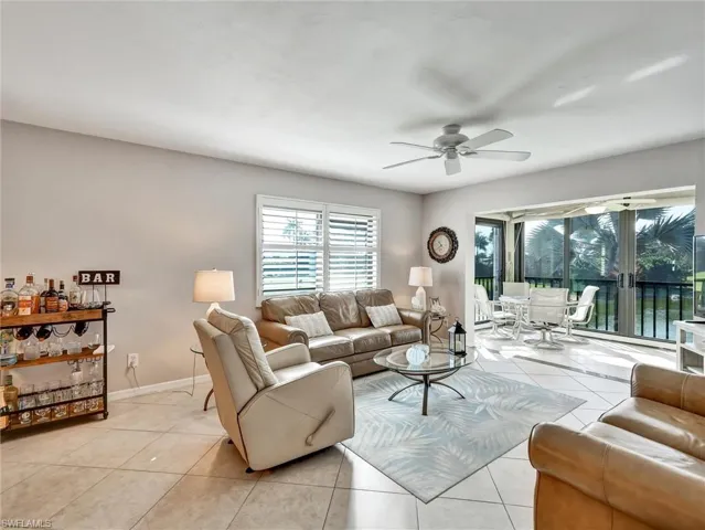Living area with ceiling fan and light tile patterned floors
