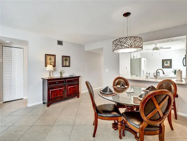 Dining area with ceiling fan and light tile patterned floors
