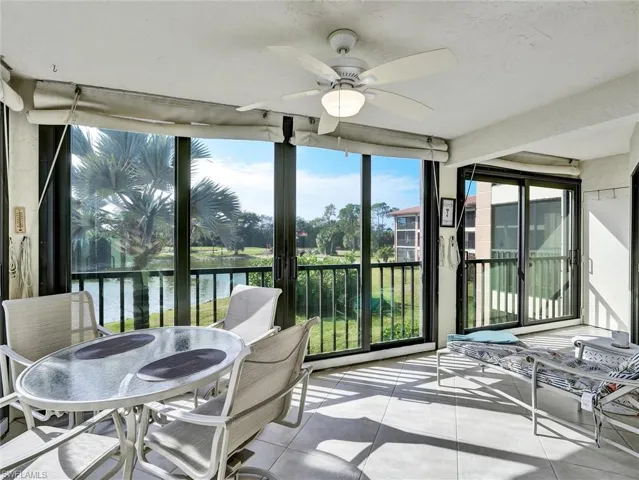 Sunroom / solarium featuring a water view