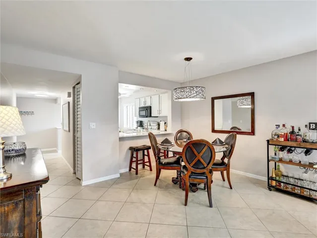 Dining room with baseboards and light tile patterned floors