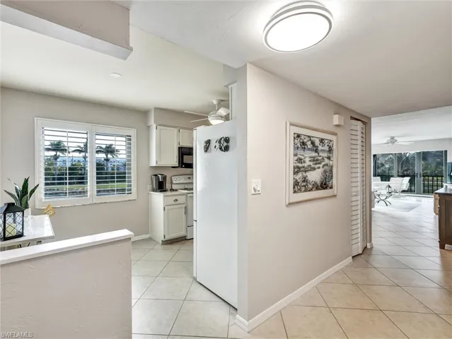 Hall featuring healthy amount of natural light and light tile patterned flooring