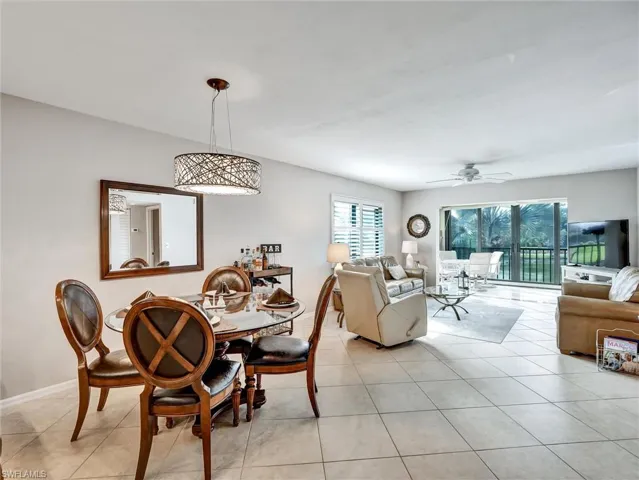 Dining space with a ceiling fan and light tile patterned flooring