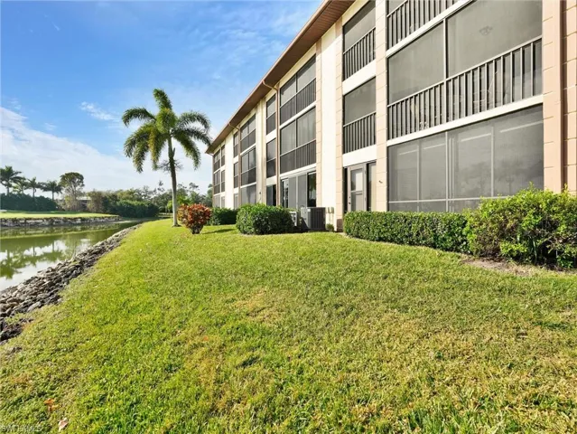 View of apartment building / complex featuring a water view