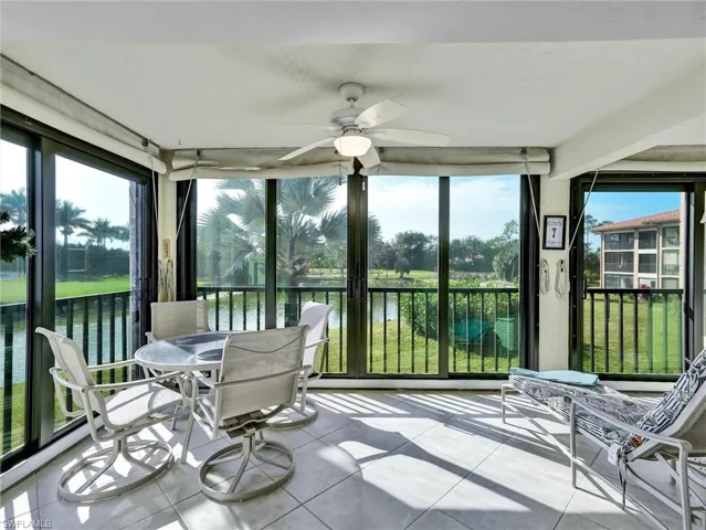 Sunroom featuring a water view and tile patterned floors