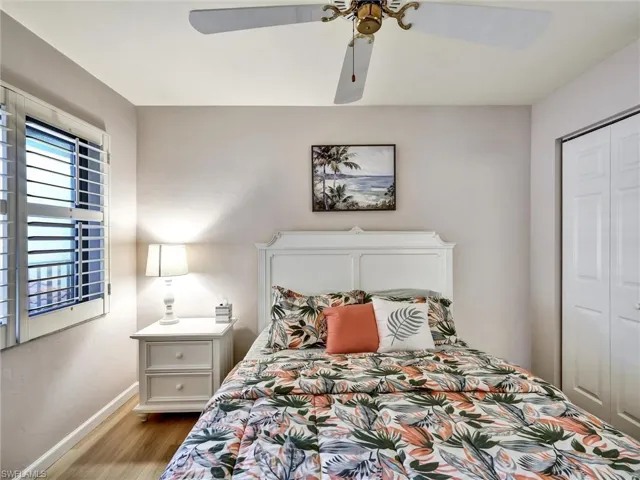 Bedroom featuring wood finished floors, ceiling fan, and a closet