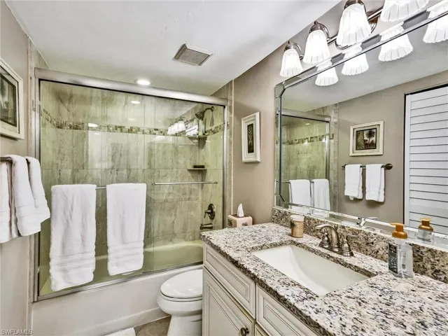 Full bathroom featuring combined bath / shower with glass door and vanity