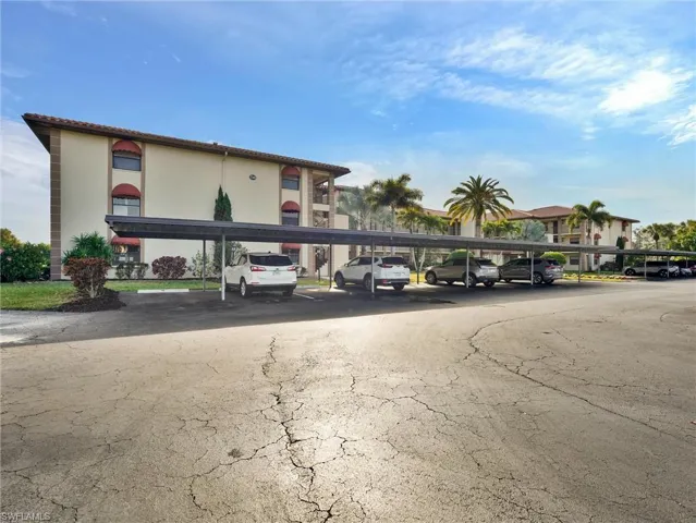 View of building exterior with covered parking