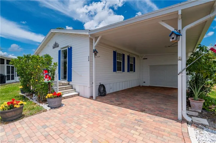 View of terrace with a garage and a carport