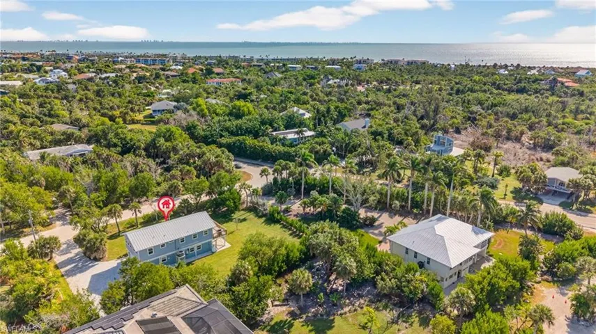 Aerial perspective of suburban area with a nearby body of water
