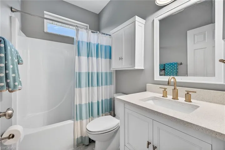 Full bath with shower / bathtub combination with curtain and vanity