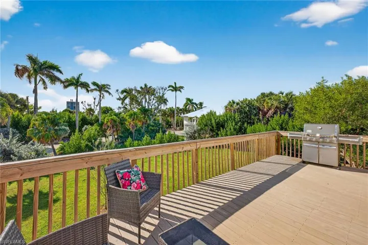 Wooden terrace with a yard and grilling area