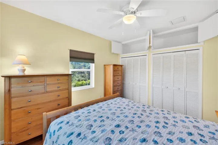 Bedroom with two closets and a ceiling fan