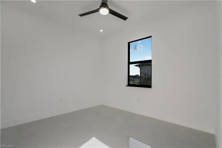 Unfurnished room featuring recessed lighting, baseboards, concrete flooring, and a ceiling fan