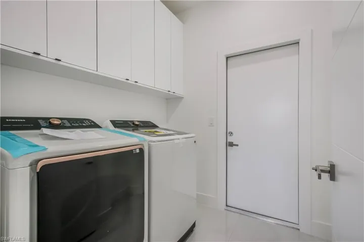Laundry room with cabinet space and independent washer and dryer
