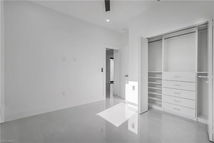 Unfurnished bedroom featuring recessed lighting, a closet, baseboards, and a ceiling fan