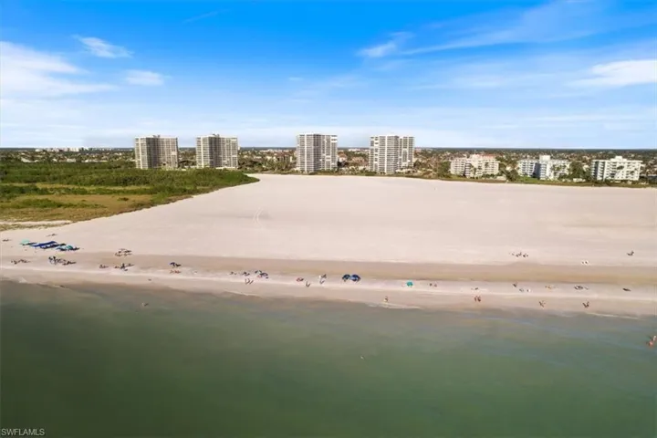 Bird's eye view with a water view and a beach view