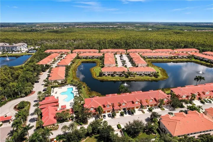 Drone / aerial view of a heavily wooded area and a large body of water