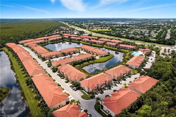 Aerial view of property's location featuring a large body of water and nearby suburban area