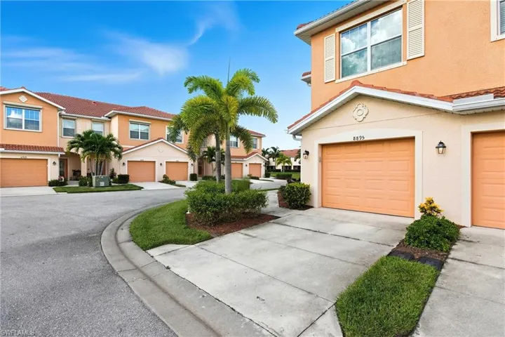 Mediterranean / spanish-style home featuring stucco siding, concrete driveway, an attached garage, and a residential view