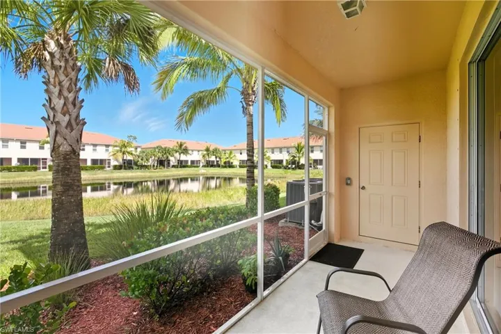 Sunroom featuring a water view