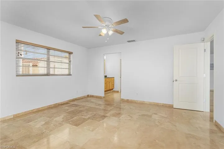 Unfurnished room featuring light tile flooring and ceiling fan