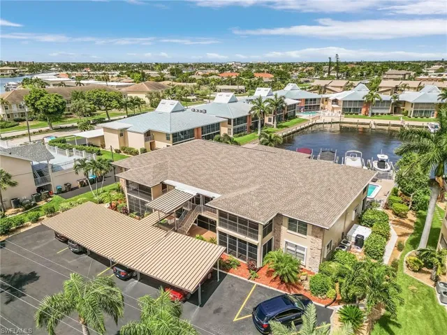 Birds eye view of property with a water view