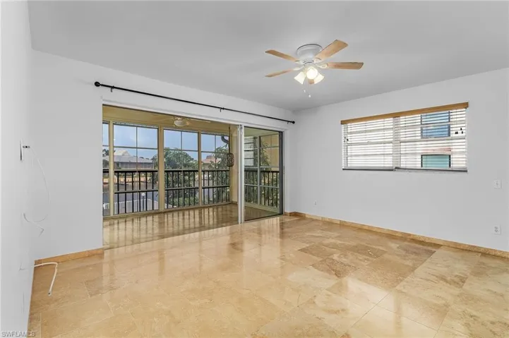 Unfurnished room featuring light tile flooring and ceiling fan