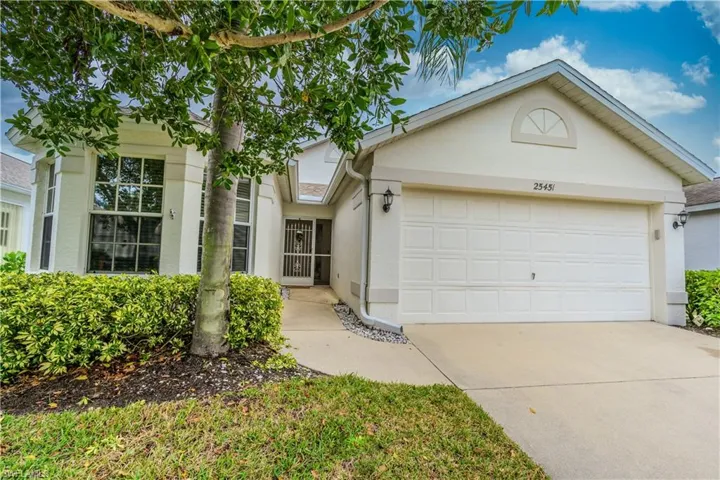 Ranch-style house with stucco siding, driveway, and a two car garage