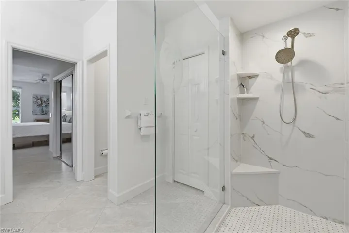 Bathroom featuring ensuite bath, a marble finish shower, and ceiling fan