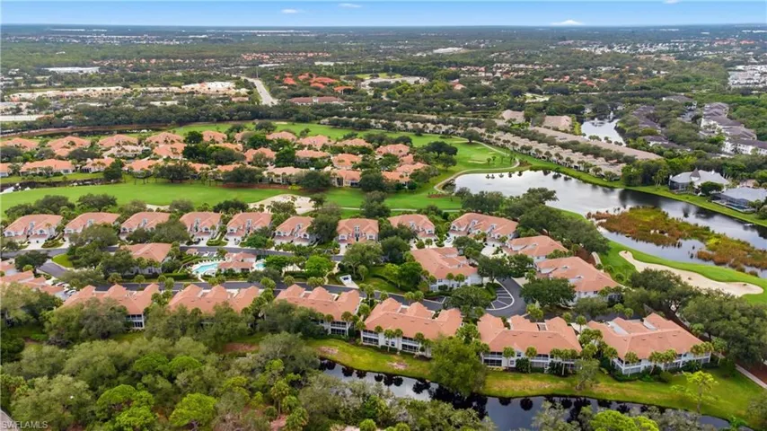 Aerial perspective of suburban area featuring a nearby body of water