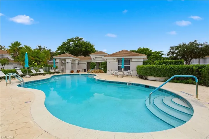 Community pool with a patio