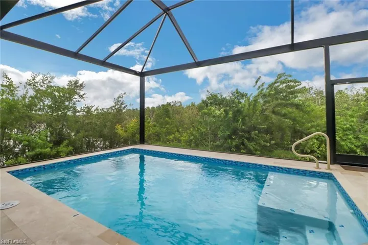 View of pool featuring glass enclosure