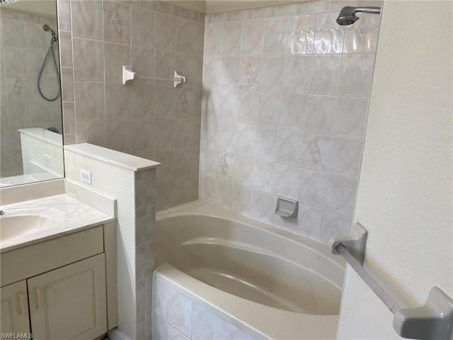 Master bath soaking tub also has a shower.