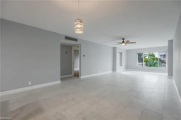 Spare room with light floors and ceiling fan