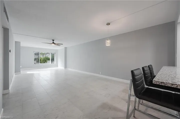 Dining space featuring baseboards and a ceiling fan
