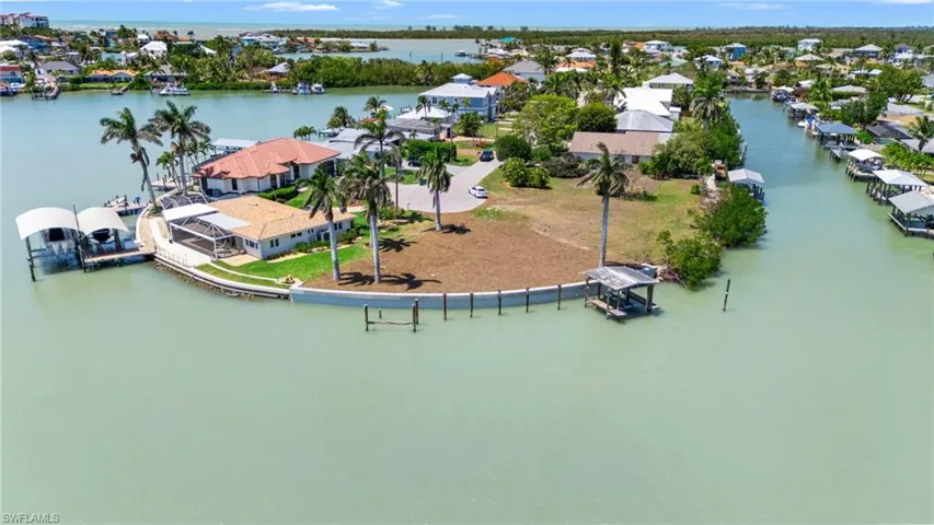 Birds eye view of property featuring a water view and a residential view