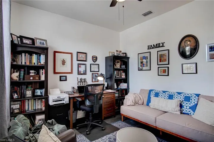 Carpeted home office with ceiling fan