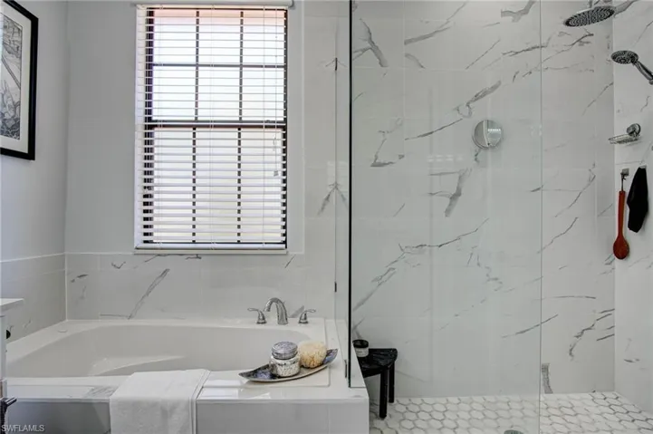 Bathroom with a healthy amount of sunlight and plus walk in shower